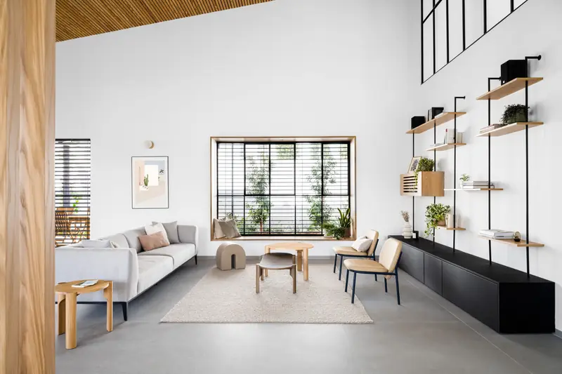 Black steel Panda® windows set into white walls in a minimalist living room