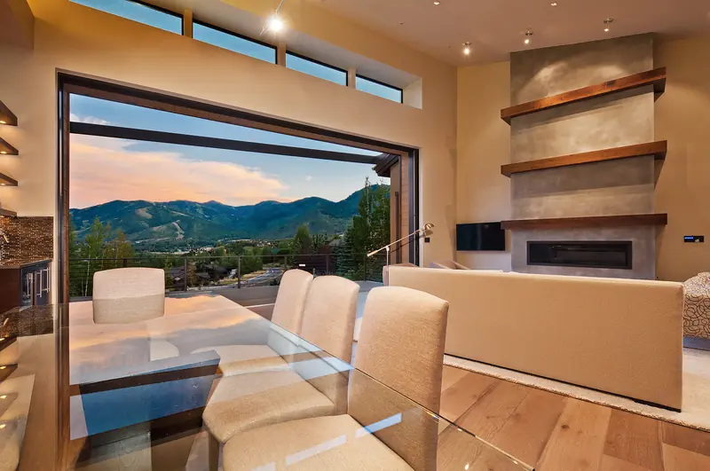 Panda® lift and slide panels open to a mountain view beside a dining table in Park City, Utah