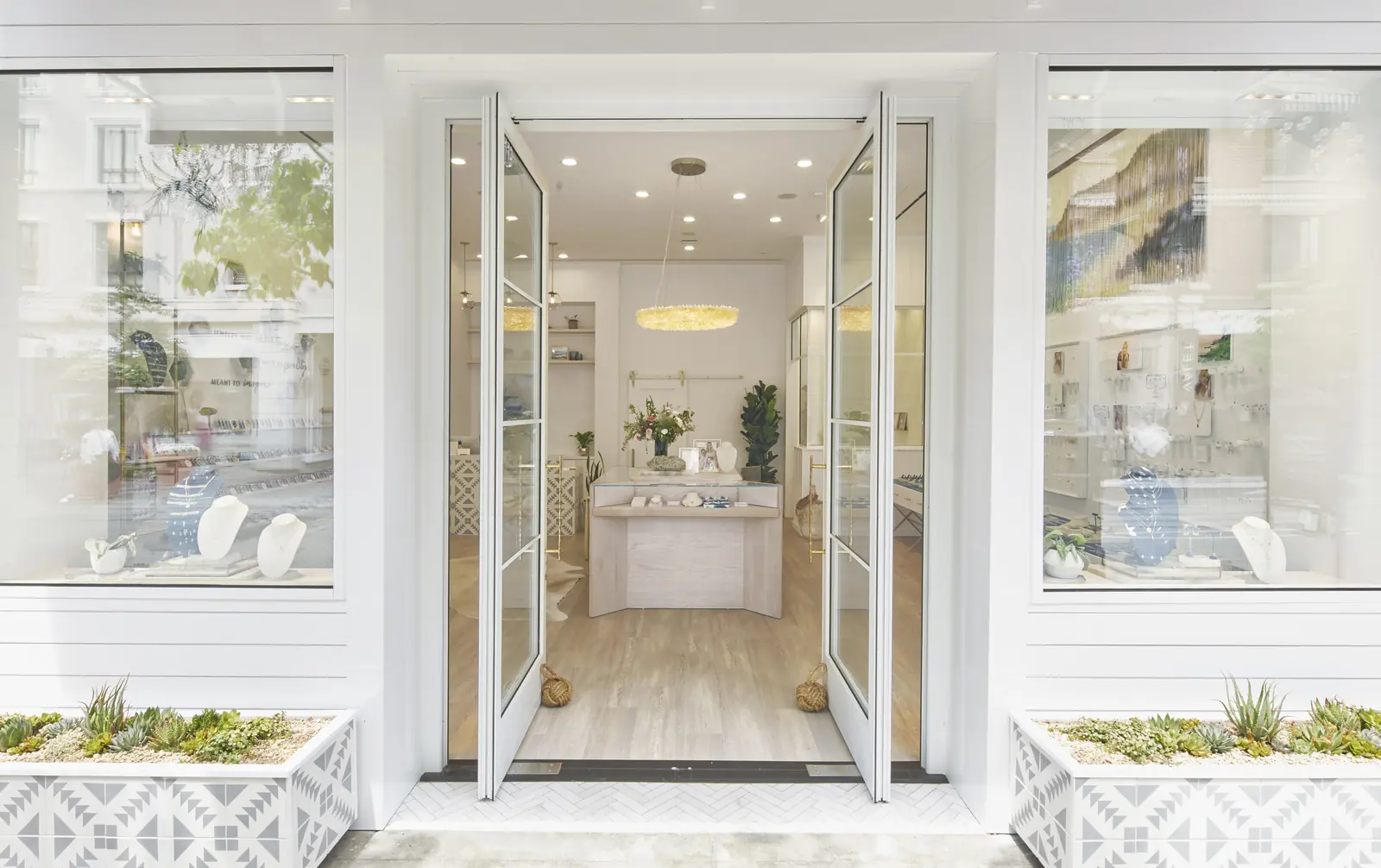 Panda® glass pivot doors open at the storefront entrance of a boutique in Glendale, California