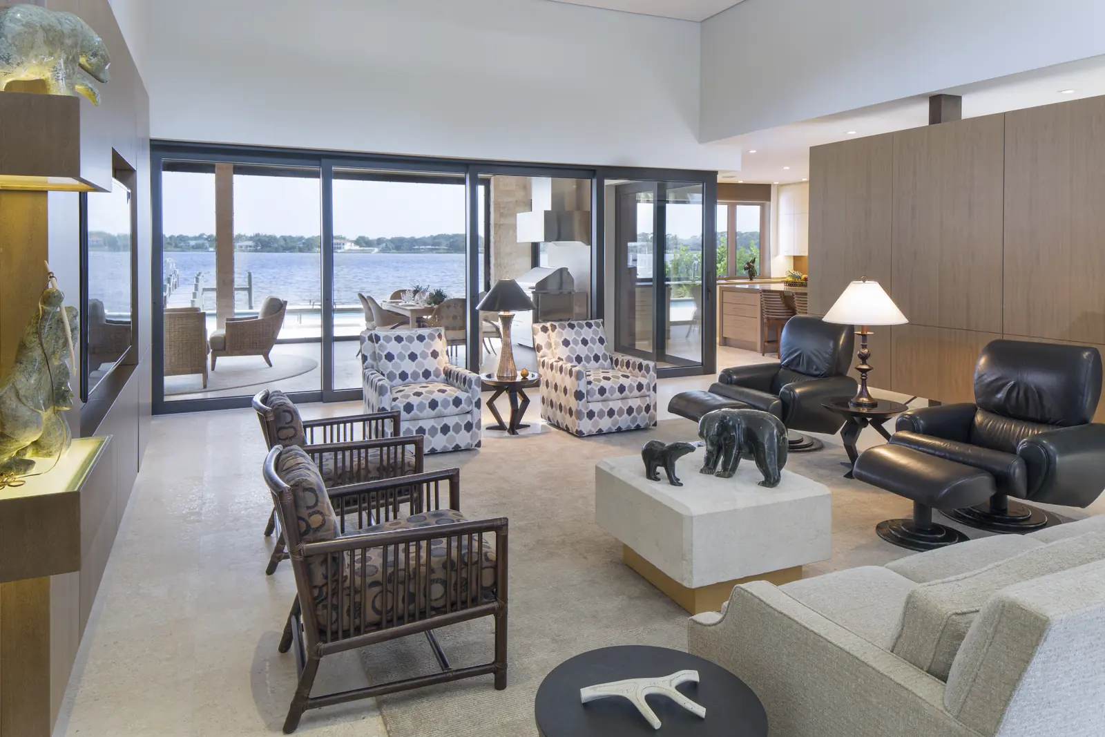 Living room lined with Panda® lift and slide doors looking out over the water at a Jupiter, Florida residence