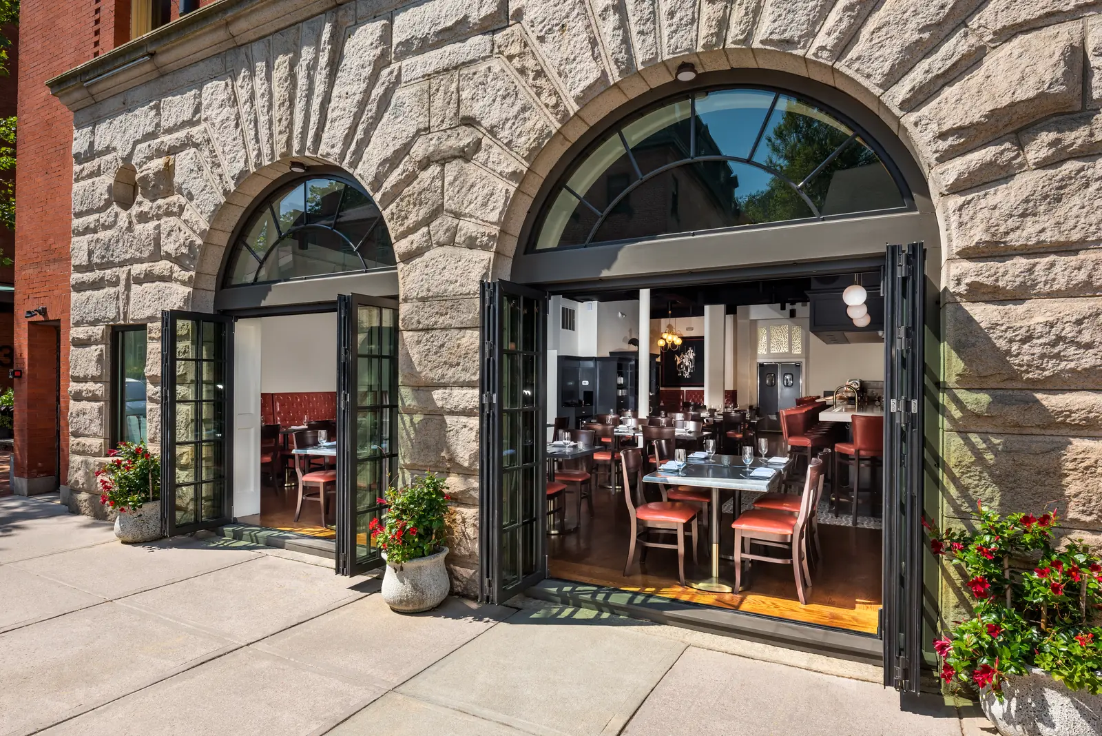 Panda® folding doors open beneath stone arches at a restaurant in Providence, Rhode Island