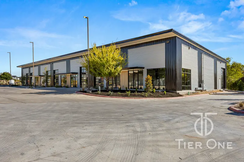 Long elevation of a flex building with storefront entries and glass overhead doors