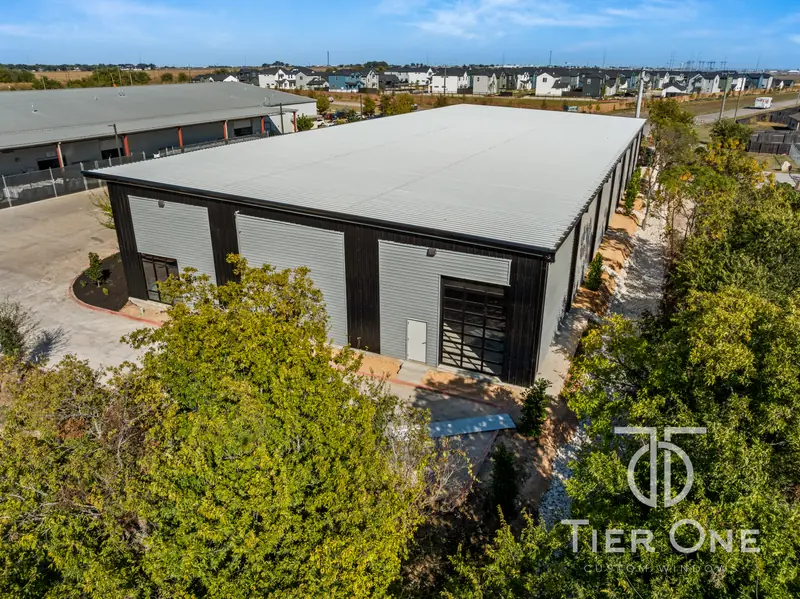Aerial view of the rear of the building with glass overhead doors