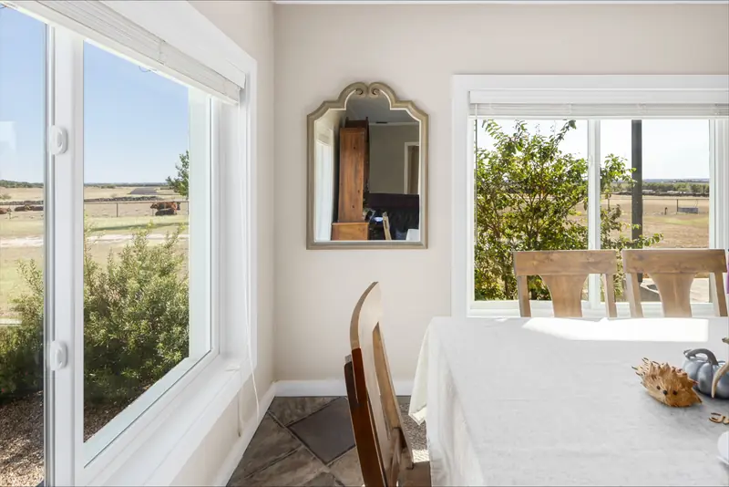 White-framed windows looking over the pasture from the dining room