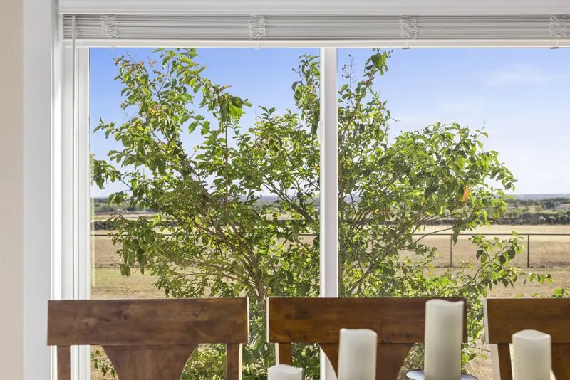 White sliding window behind a dining table