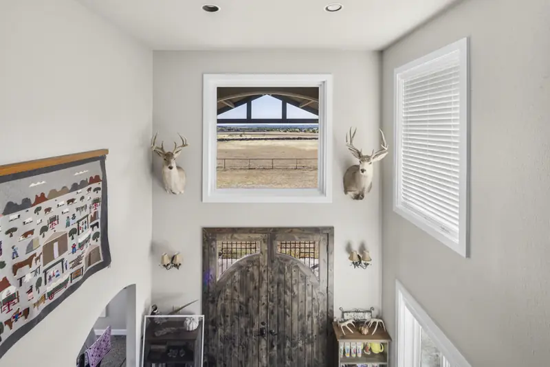 High window in a two-storey stairwell above the front door