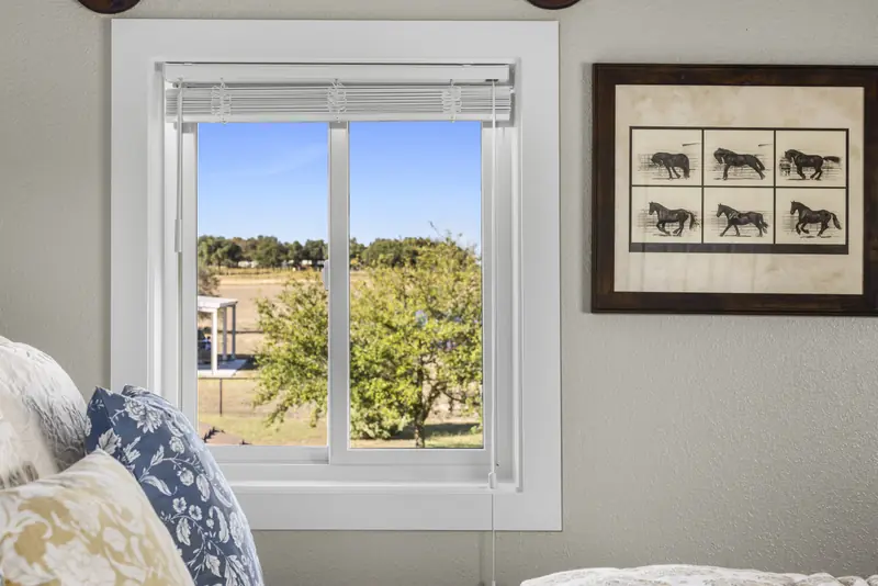 White sliding window in a guest bedroom