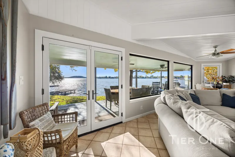 French doors to the lawn and dock with picture windows alongside