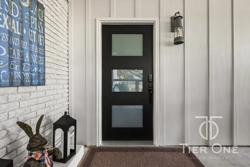 Black modern entry door with three frosted glass lites
