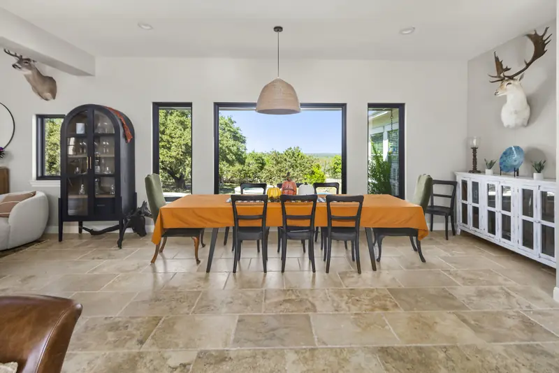 Dining room with a picture window flanked by tall black-framed units