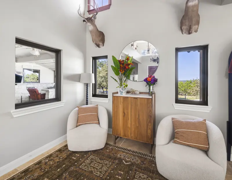 Panoramic view of a sitting room with black-framed windows
