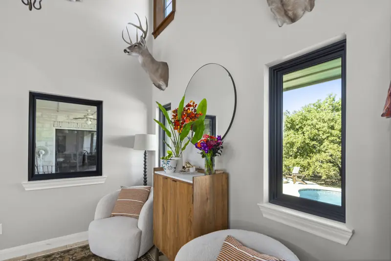 Black-framed window looking onto the pool beside an interior window