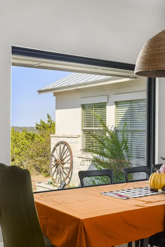 Black-framed picture window over the dining table