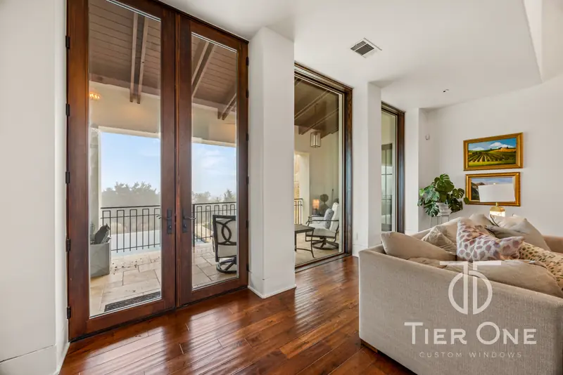 Tall French doors opening from a living room onto a balcony