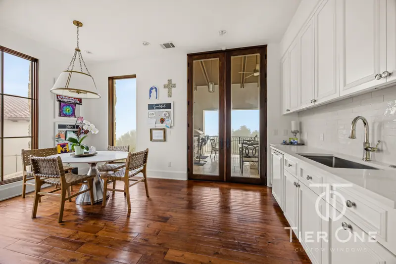 Breakfast room with French doors and a tall window beside the kitchen