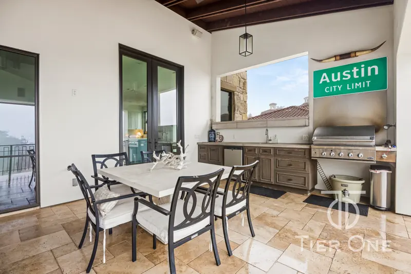 Outdoor kitchen with a French door and a window to the balcony