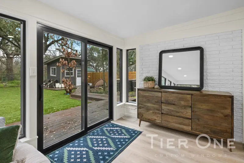 Black sliding patio door opening onto a wooden deck