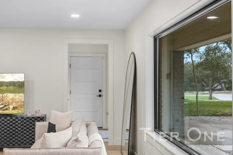 Large black-framed window beside a front door
