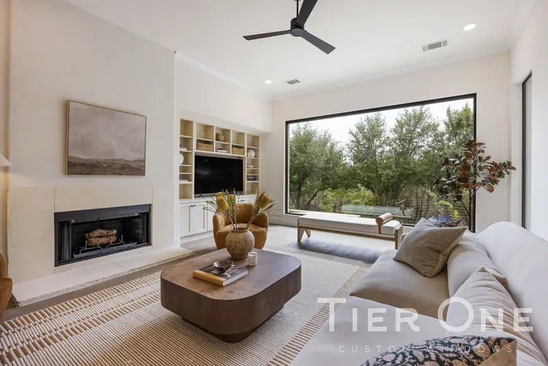 Fireplace wall beside a large black-framed picture window