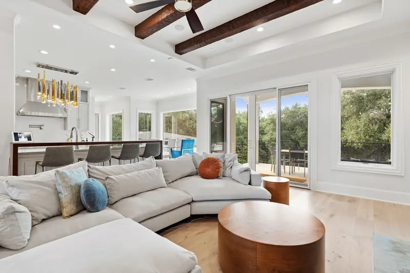 Living room and kitchen with sliding glass doors to the patio