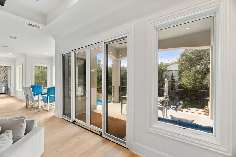 Sliding patio door and window overlooking the pool deck