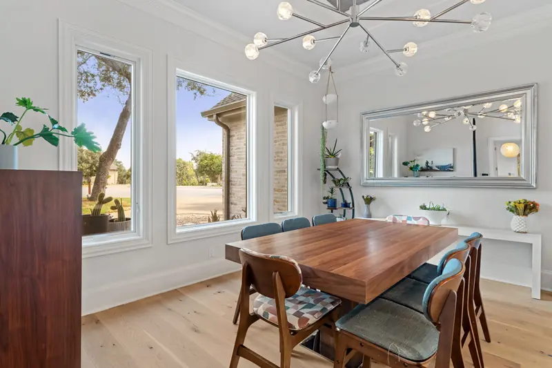 Formal dining room with tall white-framed windows to the front yard