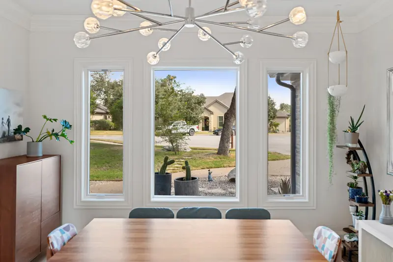 Tall white-framed windows looking onto the front yard