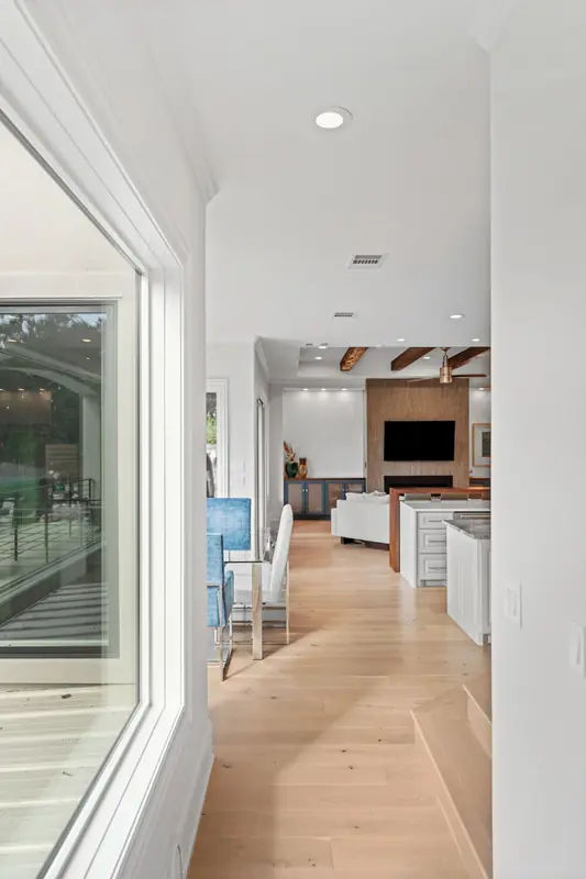 Tall window beside a hallway leading to the living room