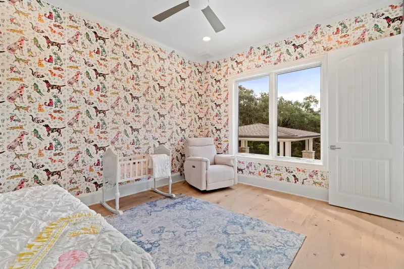Nursery with a window pair looking onto the backyard