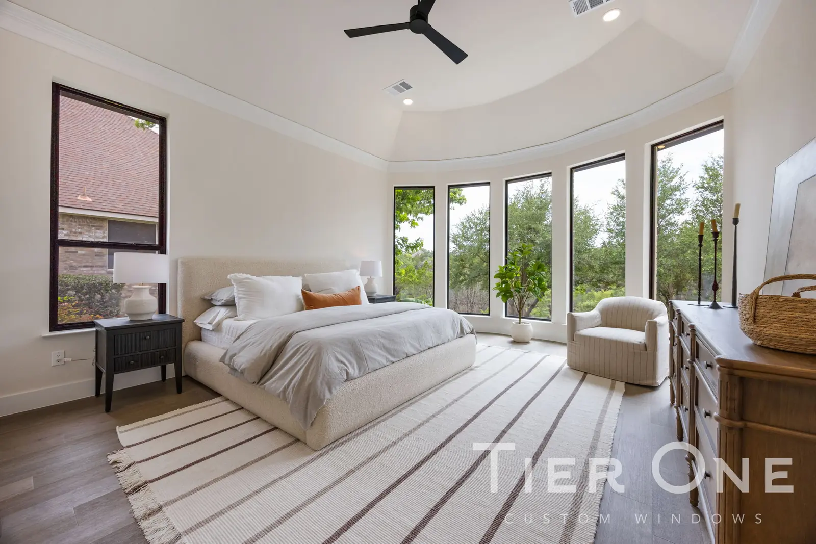 Bank of tall windows following the curved wall of a turret bedroom