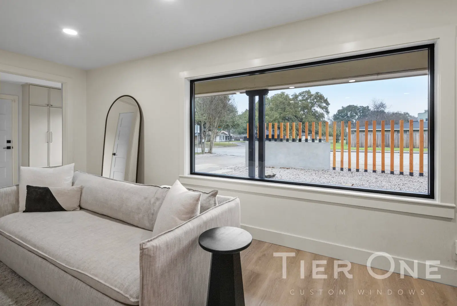 Wide black-framed picture window in a front living room