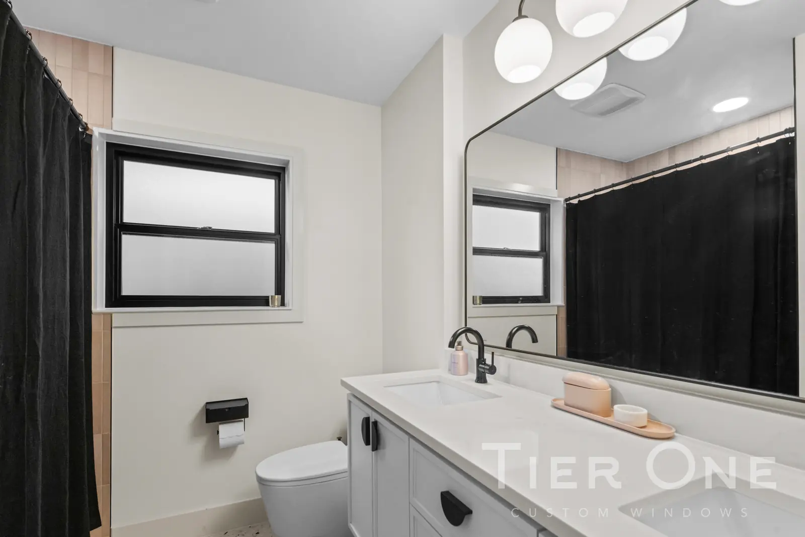 Black-framed window with obscure glass in a guest bathroom